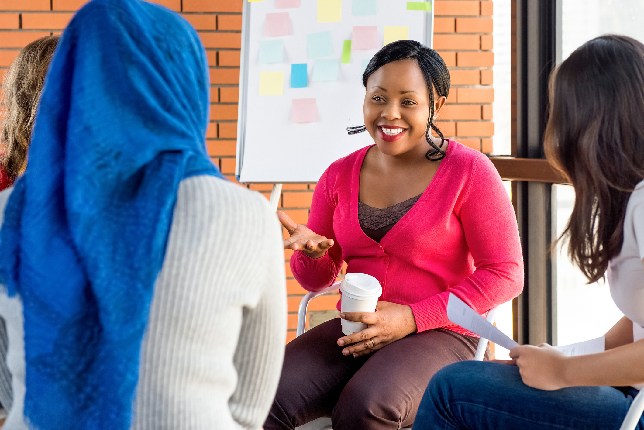 A group of people sitting down and talking